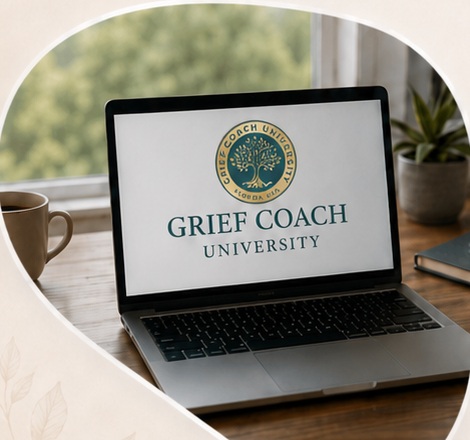 A laptop displaying the Grief Coach University logo